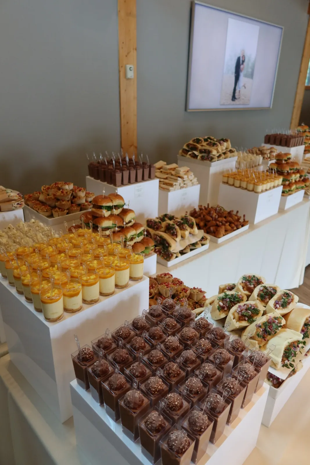 Rows of chocolate and mango dessert cups beside a grazing table of Indian-fusion appetizers by Deep's Delights