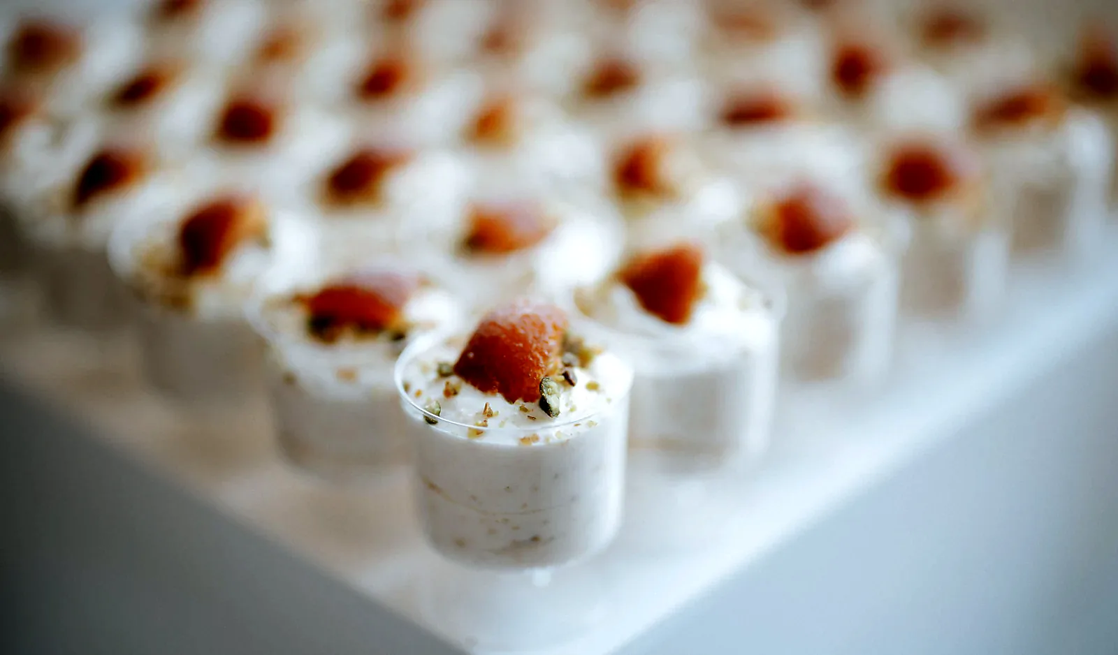 Gulab jamun mousse cups in a row, close up