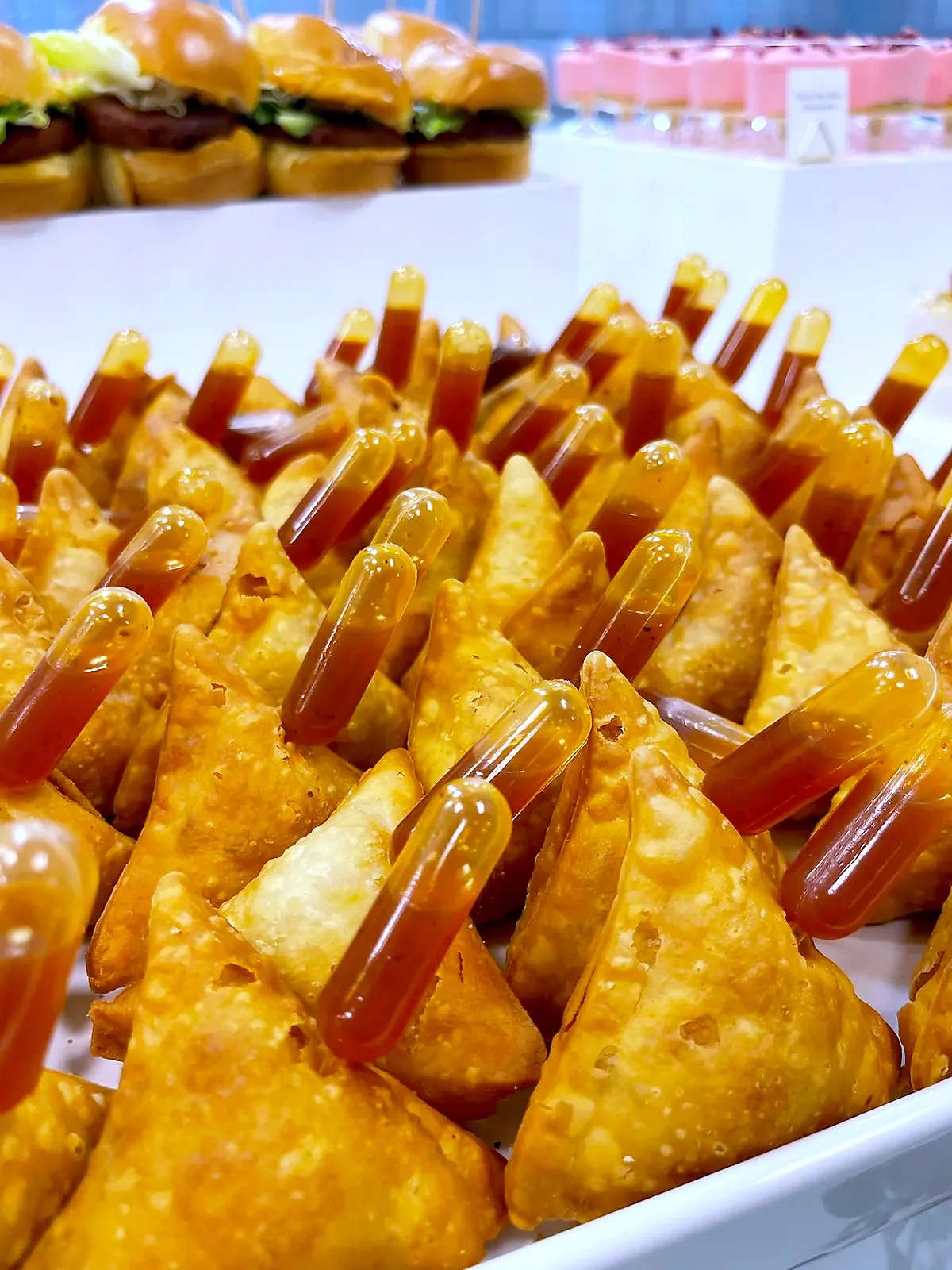Mini samosas with chutney pipettes, close up